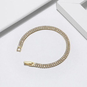 Elegant double-row round zircon tennis bracelet in gold finish with a secure clasp closure