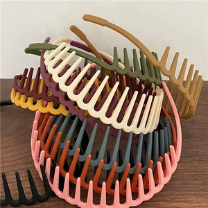 Detailed pile of colorful non-slip headbands with inner teeth in matte finish