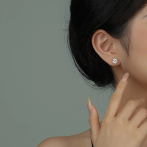 Elegant S925 sterling silver round cubic zirconia stud earrings worn by a model