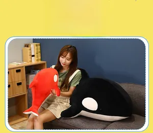 Detail of red and black orca plushies in large and small sizes with soft texture