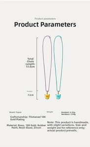 Detail of colorful heart pendants with Dream Big engraving and zircon inlay on gold chains