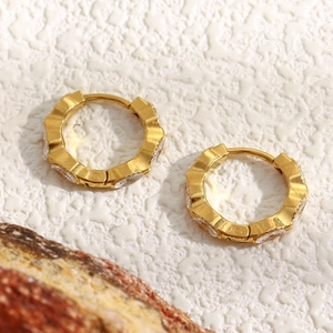 Detailed macro view of 18K gold-plated hoop earrings with sparkling marquise zircons