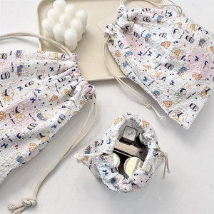 Detailed view of quilted cotton drawstring bags in three sizes for cosmetic storage
