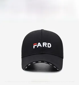 Detail of white 3D letter embroidery and printed logo on black baseball cap brim