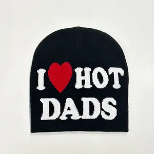 Flat lay of black knit beanie with white I Heart Hot Dads text and red heart