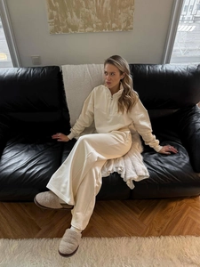 Women's cream two-piece lounge set with half-zip sweatshirt and wide-leg sweatpants
