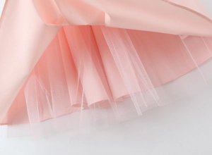 Detailed macro view of layered pink fabric and white mesh lining of the long dress