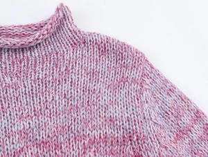 Close-up of pink and purple chunky knit texture on the ribbed stand collar and shoulder