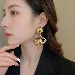 Polished gold geometric diamond drop earrings for women with bold industrial style