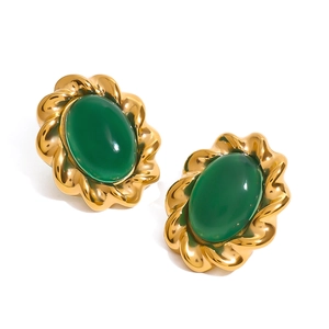 Close-up of vintage gold twisted earrings featuring oval green agate stone pendants