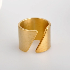 Detail of wide gold brushed stainless steel ring with minimalist geometric design