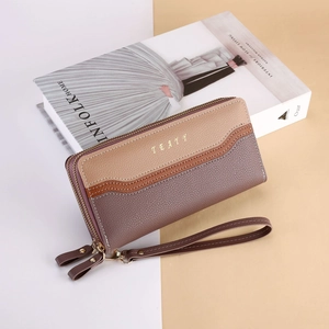 Detailed macro view of the tri-color patchwork leather wallet with dual zippers and wristlet