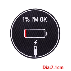 Detail view of 7.1cm round 1% I'M OK embroidered patch with low battery icon