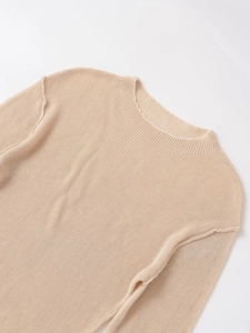 Detail showing the ribbed neckline and soft knit texture of this beige pullover sweater