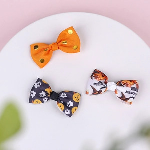 Detail view of high-quality grosgrain ribbon bow clips with Halloween ghost and pumpkin prints