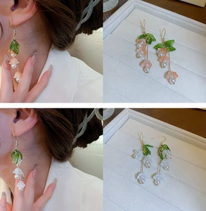 Detailed macro view of lily of the valley earrings with resin petals and pearls