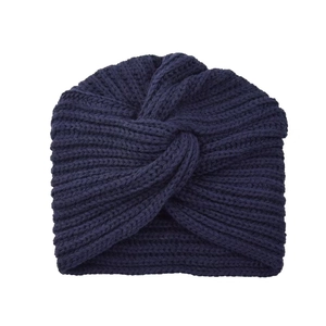 Detailed view of dark blue chunky knit turban hat with cross-knot design and vertical texture