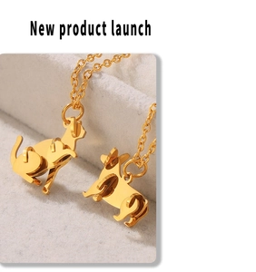 Macro detail of 18k gold plated cat pendant necklace with polished finish on velvet
