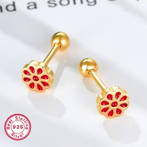Macro view of 925 sterling silver flower earrings with red enamel and gold finish