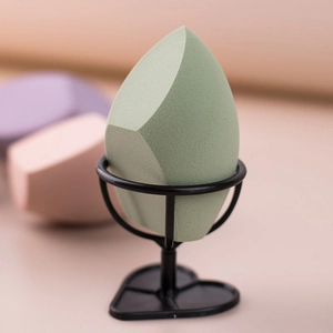 Jumbo green makeup sponge with heart-shaped metal holder for flawless makeup application