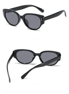 Detailed views of vintage black cat-eye sunglasses with thick frames and metal dot accents