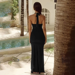 Vue arrière d'une robe noire dos nu licou avec un ourlet sirène à volants élégant