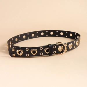 Close-up of black faux leather belt with golden heart-shaped and round metal eyelets