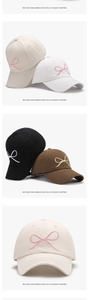 Detail of embroidered bow design on cotton baseball caps in multiple colors