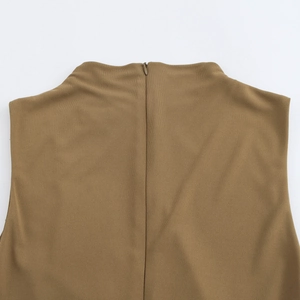 Detail shot of invisible zipper and high neck collar on back of brown sleeveless dress