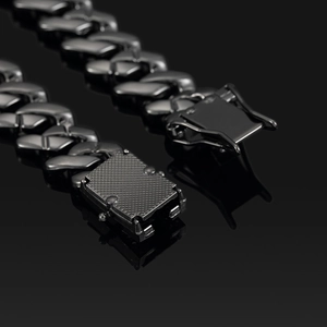 Detail shot of the heavy 14mm black Cuban link chain with textured box clasp and diamonds