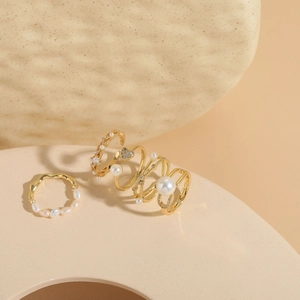 Detailed shot of gold plated freshwater pearl rings with zircon insets on ceramic stand