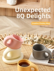 Detail of round ceramic mugs with thick handles on bamboo mats in a cozy setting