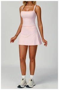 Detail view of pink cross-strap sports dress showing breathable fabric and slim fit design