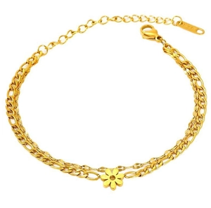 Detail of double-layer gold Figaro chain bracelet with daisy flower charm pendant