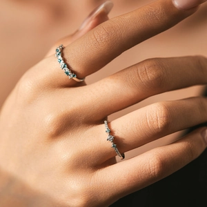 S925 sterling silver rings with mint green and clear crystals worn on female hand