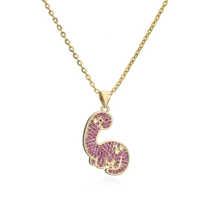 Detailed view of pink zircon dinosaur pendant with gold-plated chain and black stone eyes