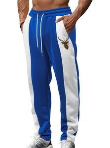 Detail of men's color-block jogger pants with white drawstring and deer head logo print