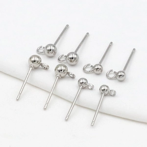 Macro shot of silver round bead ear pins with hanging loop for DIY jewelry making