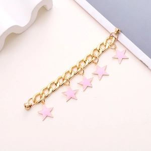 Detail of gold Cuban link chain with pink star charms and a magnetic clasp closure