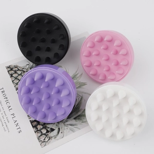 Top view of four colorful silicone scalp massage brushes with 19 soft conical teeth