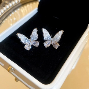 Gros plan de boucles d'oreilles papillon avec ailes en zircon dans une boîte à bijoux