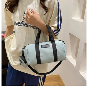 Detail of light blue nylon Boston bag with matching detachable mini coin purse and shoulder strap