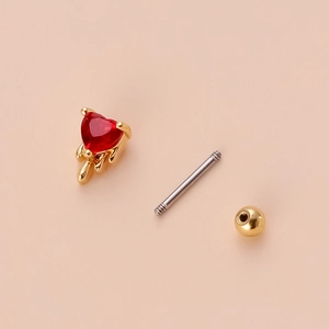 Detail view of disassembled gold lava drip earring with red heart zircon and screw ball back