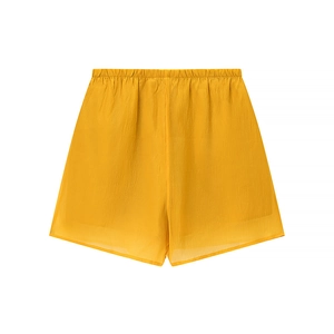 Detail of bright yellow textured lightweight shorts with an elastic waistband design