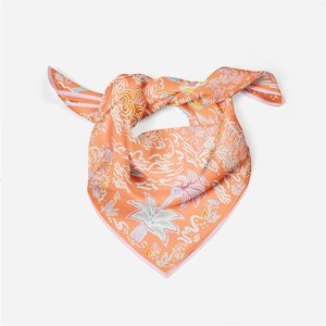 Detail of knotted orange silk square scarf with colorful palm tree and wave patterns