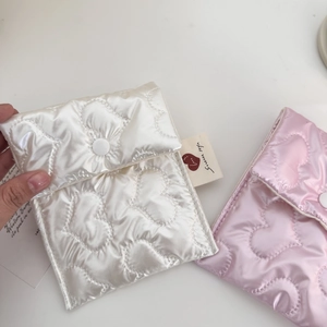 Detail of pink and white heart quilted sanitary pad storage pouch with snap closure