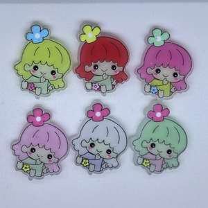 Flat lay of colorful resin cartoon star girl accessories for DIY phone cases and hair clips