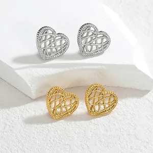 Minimalist mesh hollow heart earrings in gold and silver finish on white stone stand