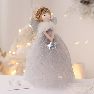 Christmas angel doll with silver glitter wings and star against warm festive lights