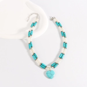 Detail of bohemian turquoise stone beads and heart pendant on double-layer necklace